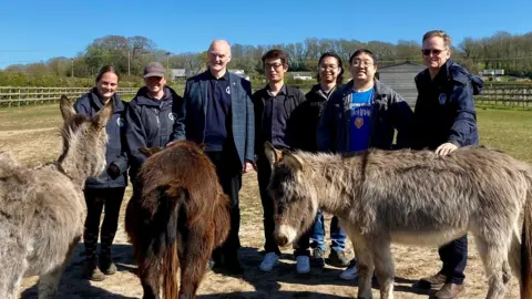 AI to help tell donkeys apart at island sanctuary - 1751712098 277 AI to help tell donkeys apart at island sanctuary.webp Isle of Wight Donkey Sanctuary/University of Southampton A group of seven people looking at the camera, including staff from the donkey sanctuary and scientists from the University of Southampton. There are 3 donkeys in front of them and fields and fences behind them.