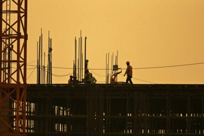 Men work at under construction site in New Delhi